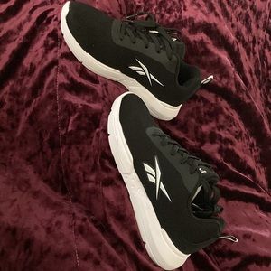 Black and white Reebok sneakers, perfect for working out or running errands.